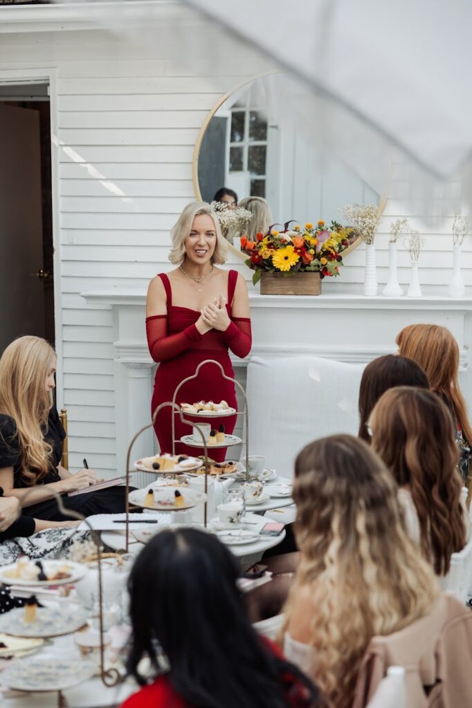 PR and Personal Branding Expert for entrepreneurs Katrina Owens speaking at one of her events in a red dress