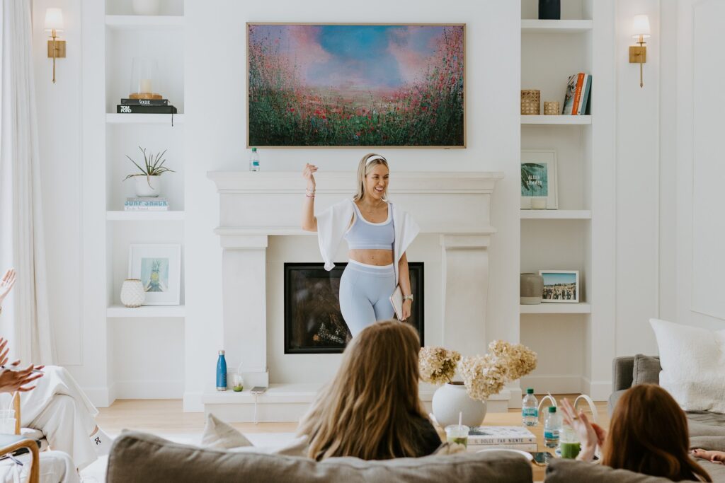 Personal Branding Coach Katrina Owens stands at the centre of a modern neutral living room in front of entrepreneurs learning about personal branding