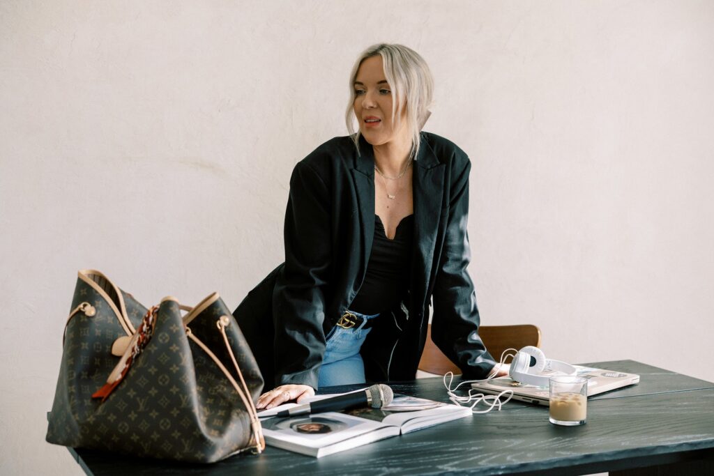 Public relations expert and personal branding strategist Katrina Owens sets up her desk in jeans and a black blazer so she can work on her personal branding keynote