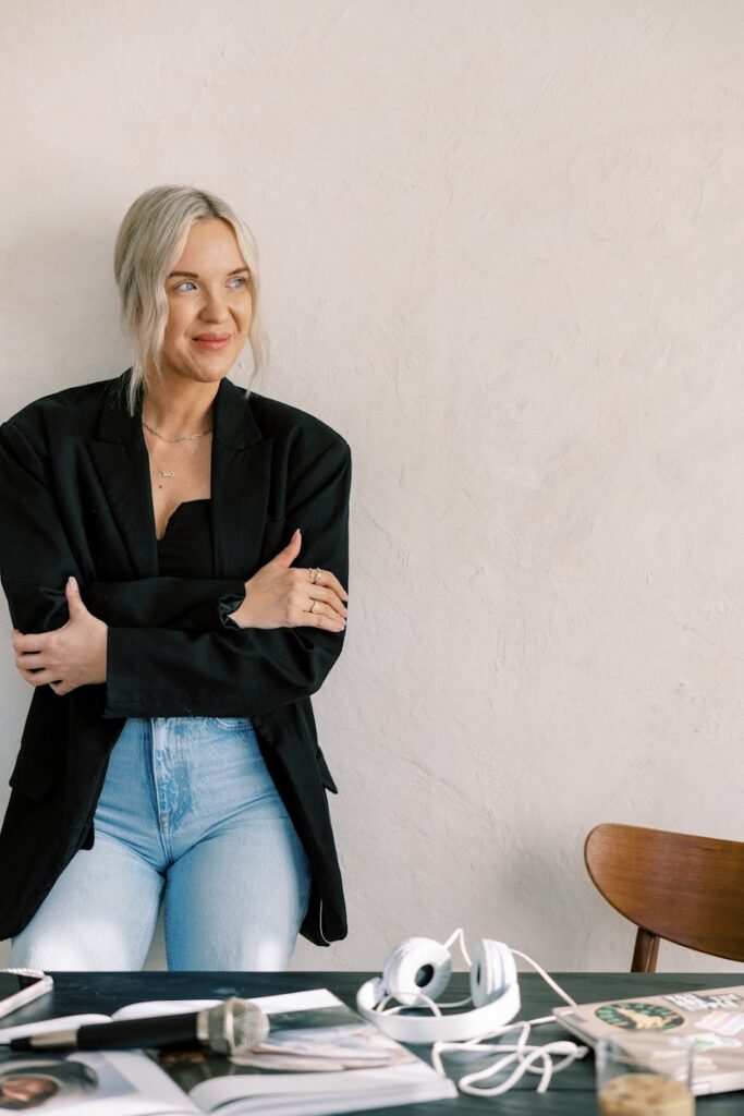 Public relations for personal brands expert Katrina Owens stands in a black blazer creating content for entrepreneurs, executives and leaders who want to build a personal brand