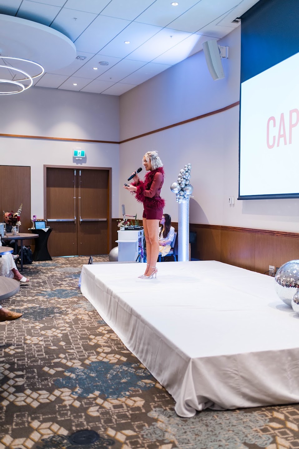 Personal Brand Speaker Katrina Owens delivers a keynote to a large audience on stage